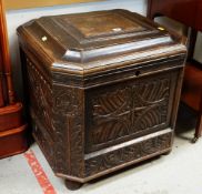 AN EARLY 20TH CENTURY CARVED OAK SQUARE CELLARETTE, hinged lid and fitted interior for bottles