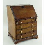 19TH CENTURY MINIATURE MAHOGANY BUREAU, angled fall with fitted interior, bracket feet, 21.5 x 18