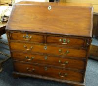 GEORGE III MAHOGANY BUREAU, angled fall enclosing fitted interior with later carved drawers and