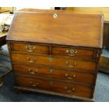 GEORGE III MAHOGANY BUREAU, angled fall enclosing fitted interior with later carved drawers and