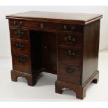 GEORGE III MAHOGANY KNEEHOLE DESK / CARD TABLE, moulded foldover top fitted with baize, above