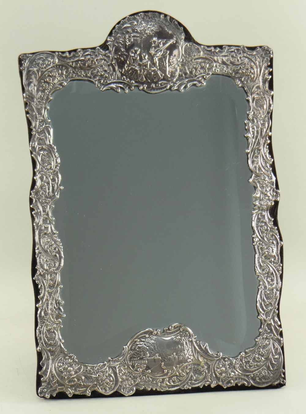 VICTORIAN-STYLE EMBOSSED SILVER EASEL-BACK MIRROR, London 1990 by M&LS, decorated with