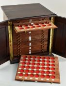 GOOD QUALITY COIN COLLECTOR'S CABINET, the two blind panelled doors revealing 28 removable coin