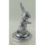 SEATED RABBIT CAR MASCOT, by Desmo, 11.5cms high on octagonal mount Condition Report: slight wear