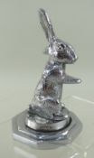 SEATED RABBIT CAR MASCOT, by Desmo, 11.5cms high on octagonal mount Condition Report: slight wear