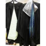 SCHOLASTIC ROBES: two black gowns, two hoods with the coloured silk edging and a mortar board,
