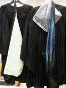 SCHOLASTIC ROBES: two black gowns, two hoods with the coloured silk edging and a mortar board,