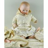 K.B 241 GERMAN BISQUE HEAD BABY DOLL, c. 1910, with jointed composition body, weighted blue glass
