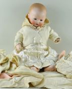 K.B 241 GERMAN BISQUE HEAD BABY DOLL, c. 1910, with jointed composition body, weighted blue glass