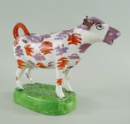 SWANSEA CAMBRIAN POTTERY COW CREAMER, iron red and pink lustre splashed decoration with black detail