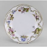 A NANTGARW PORCELAIN PLATE DECORATED BY WILLIAM POLLARD of alternate lobed form, the border