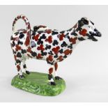 A SWANSEA CAMBRIAN PEARLWARE COW CREAMER typically modelled with tail loop-handle and standing on