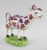A SWANSEA CAMBRIAN PEARLWARE COW CREAMER typically modelled with tail loop-handle and standing on