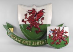 TWO PAINTED WOODEN WELSH DRAGON PLAQUES the dragons relief carved, 58cms and 25cms high, together