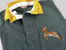 A 1951 SOUTH AFRICA SPRINGBOK RUGBY UNION JERSEY bearing embroidered prancing Springbok crest,