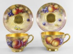 TWO ROYAL WORCESTER PORCELAIN CABINET TEA CUPS & SAUCERS, painted with apples, plums and grapes by