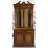 EDWARDIAN WALNUT BOOKCASE, carved cornice, door tops and cupboards, base with two frieze drawers