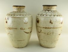 TWO CHINESE CIZHOU STONEWARE JARS, cream slip glazed with brown painted decoration, 50cms high (2)