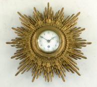 FRENCH SUNBURST WALL TIMEPIECE, 2 3/4 inch white enamel dial in giltwood case, 27cms diam. Condition