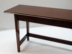 MODERN MAHOGANY NARROW SIDE OR SERVING TABLE, moulded top on square tapering legs tied by three