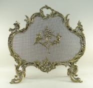 LOUIS XV-STYLE ROCOCO REVIVAL BRASS FIRE SCREEN, later mesh applied with brass cupids flaming a