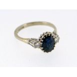 18CT WHITE GOLD SAPPHIRE & DIAMOND RING, the central sapphire (7 x 6mms) flanked by two diamonds,