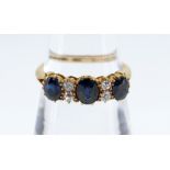 18CT GOLD SAPPHIRE & DIAMOND RING, the three sapphires separated by two pairs of diamonds, claw set,