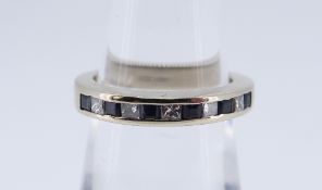 18CT WHITE GOLD ELEVEN STONE DIAMOND & SAPPHIRE RING, ring size K, 4.9gms, in black square ring