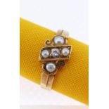 18CT GOLD PEARL & DIAMOND RING of scroll and cross design having a central diamond (0.05cts approx.)