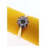 18CT GOLD DIAMOND ILLUSION SET RING, the central stone 0.1cts approx., ring size K, 3.4gms, in black