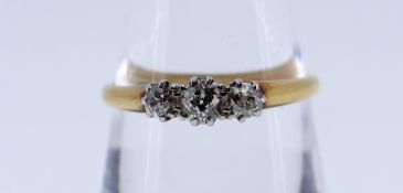 18CT GOLD & PLATINUM THREE STONE DIAMOND RING, claw set, ring size Q, 2.3gms, in green heart