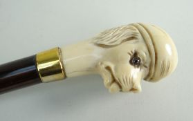 19TH CENTURY CONTINENTAL IVORY MOUNTED WALKING CANE, handle carved as a dog's head wearing a cloth