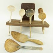 MAHOGANY SPOON RACK with five vintage spoons, a scoop and a South East Asian coconut and horn