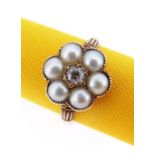 18CT GOLD DIAMOND & PEARL RING of flower head design with central old European cut diamond (0.