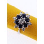 18CT WHITE GOLD SAPPHIRE & DIAMOND CLUSTER RING of flower head design comprising six sapphire and
