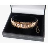 9CT GOLD DIAMOND SET BANGLE, scroll design, 13.4gms, in black box Condition Report: appears in