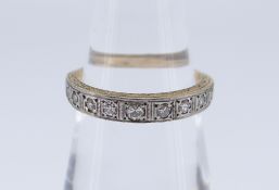 YELLOW METAL DIAMOND HALF ETERNITY RING having eleven graduating diamonds, ring size O, 3.4gms, in