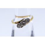YELLOW METAL THREE STONE DIAMOND RING, illusion set on twist shank, 0.2cts overall approximately,