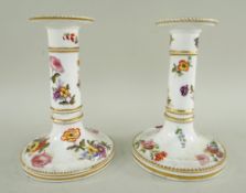 PAIR 19TH CENTURY STAFFORDSHIRE PORCELAIN TABLE CANDLESTICKS, painted with sprays of summer