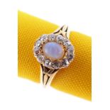 18CT GOLD OPAL & DIAMOND CLUSTER RING, the central opal (5 x 4mms) surrounded by twelve diamonds,