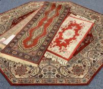 THREE EASTERN STYLE CARPETS all red ground with traditional and floral patterns including an