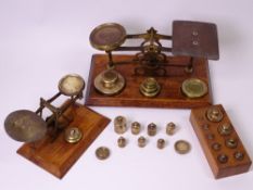 TWO SETS OF SMALL POSTAL SCALES WITH WEIGHTS, 20cms the widest