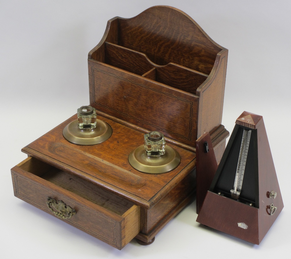 CIRCA 1900 OAK TABLETOP STATIONERY/PEN STAND and a modern mahogany effect metronome, 31cms H,