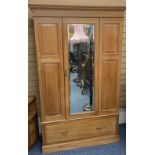 CIRCA 1900 STRIPPED SATINWOOD WARDROBE having a single mirrored door, the glass bevel edged over a