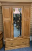 CIRCA 1900 STRIPPED SATINWOOD WARDROBE having a single mirrored door, the glass bevel edged over a