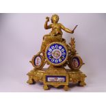 FRENCH MANTEL CLOCK gilt metal with painted enamel dial and porcelain plaques, 32cms H, 26cms W,