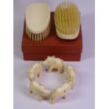 19TH CENTURY IVORY CIRCULAR TRAIN OF ELEPHANTS and a pair of Edwardian clothes brushes