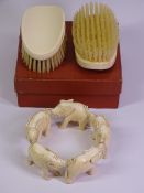 19TH CENTURY IVORY CIRCULAR TRAIN OF ELEPHANTS and a pair of Edwardian clothes brushes