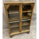 VINTAGE OAK TWO DOOR GLAZED BOOKCASE having bevelled edging to the glass and interior adjustable