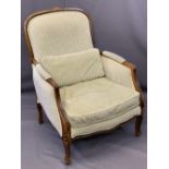 FRENCH STYLE WALNUT & UPHOLSTERED ARMCHAIR having striped, green upholstery and feather filled